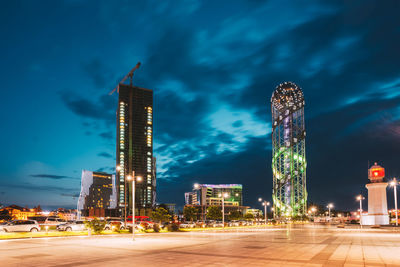 Illuminated buildings against sky at night