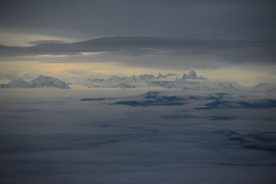 Aerial view of snowcapped mountains against sky