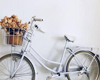 Autumn theme. wilted roses inside the bicycle busket 