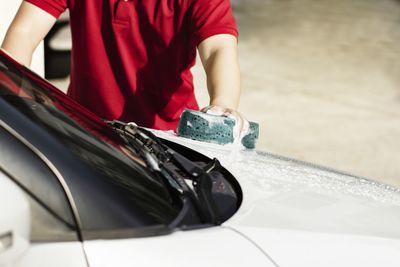 Close-up of man holding red car