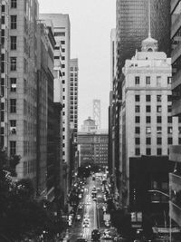 Traffic on road amidst buildings in city