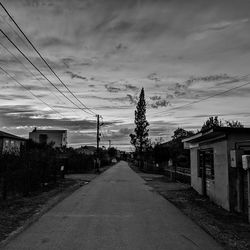 Road amidst buildings against sky