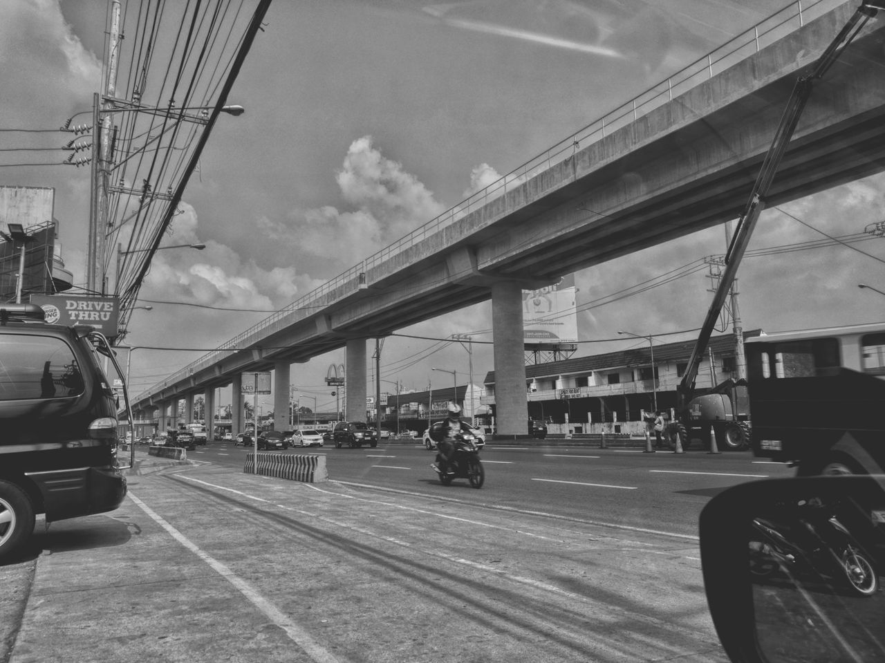 transportation, sky, mode of transport, cloud - sky, bridge - man made structure, architecture, land vehicle, travel, connection, built structure, outdoors, day, public transportation, city, no people