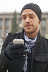 Portrait of young man using mobile phone