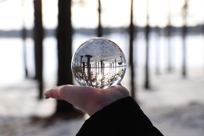 Close-up of hand holding crystal ball