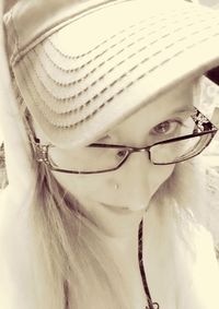 Close-up portrait of young woman wearing hat