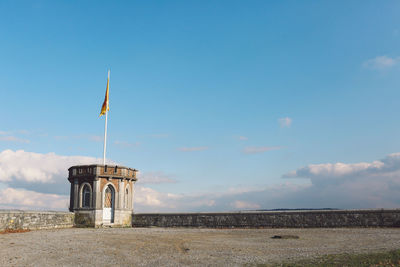 Tower on beach against sky