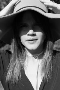 Close-up portrait of young woman wearing hat