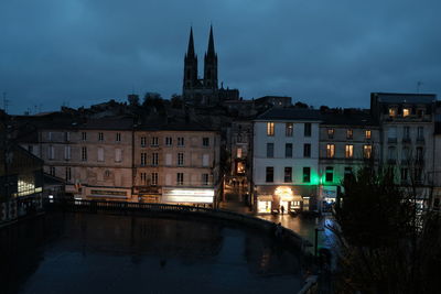 View of illuminated buildings against sky at dusk