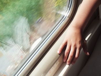 Blurred motion of man seen through train window