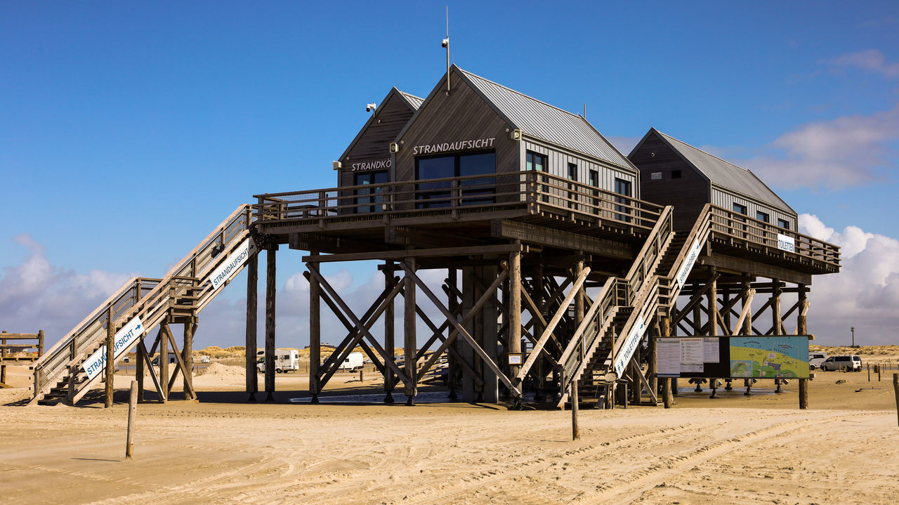 architecture, built structure, sky, beach, nature, land, building exterior, sand, water, day, no people, outdoors, blue, hut, cloud, building, travel destinations, industry, sea, sunny