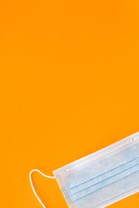 High angle view of paper against orange background