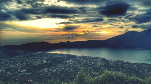 Scenic view of lake against dramatic sky