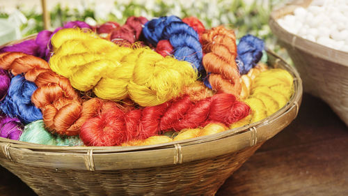 Close-up of multi colored wicker basket on table