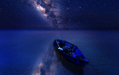 Boat in sea against sky at night