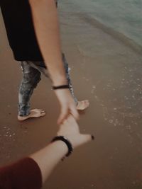 Low section of woman walking on beach