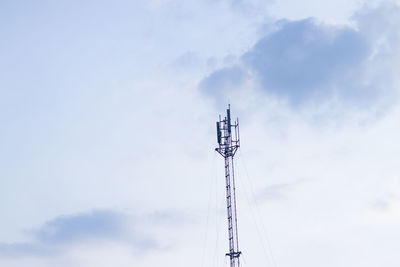 Low angle view of communications tower against sky