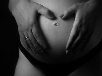 Midsection of woman touching hair