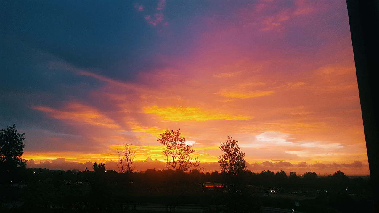 sunset, orange color, silhouette, sky, beauty in nature, tree, tranquil scene, scenics, nature, cloud - sky, tranquility, no people, dramatic sky, outdoors, built structure, building exterior, architecture, day