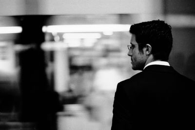 Rear view of businessman standing in office