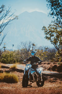 Man riding motorcycle on road