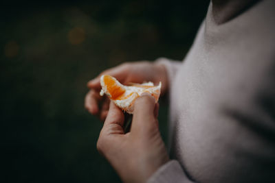 Close-up of hand holding orange