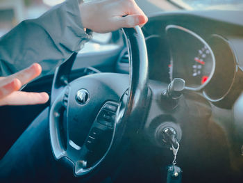 Close-up of hand holding car
