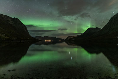 Scenic view of lake against sky at night