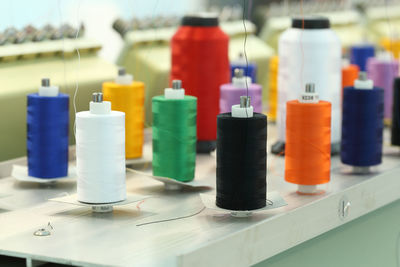 Close-up of multi colored bottles on table