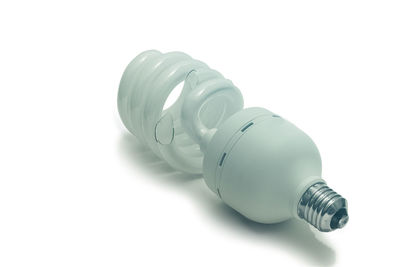 Close-up of light bulb against white background