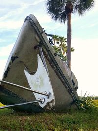 Abandoned car on field against sky