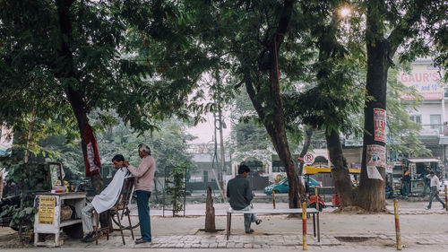 People sitting on seat in city