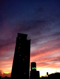 Low angle view of building against sky at sunset