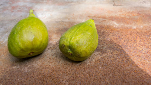 Close-up of green fruits on floor