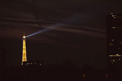 Low angle view of illuminated tower at night