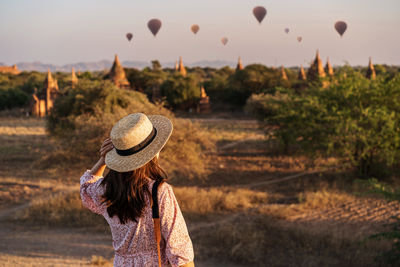 Rear view of woman with balloons