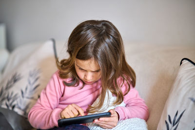 Girl using mobile phone at home