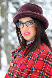 Portrait of smiling young woman wearing hat