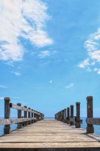 Pier over sea against blue sky