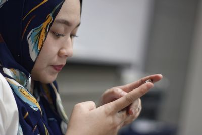 Close-up of young woman using mobile phone