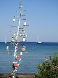 Sailboat in sea against clear sky