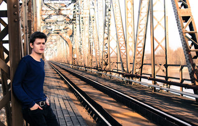 Portrait of man standing on railroad tracks