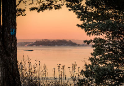 Scenic view of lake against sky during sunset