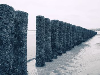 Scenic view of beach against sky during winter