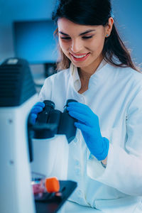 Biology student researcher looking through the microscope