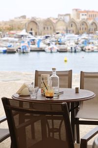 Chairs and table at cafe against restaurant