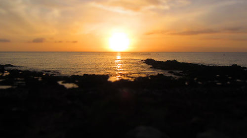 Scenic view of calm sea at sunset