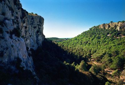 Scenic view of rocky mountains against clear blue sky