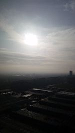 Aerial view of city against cloudy sky