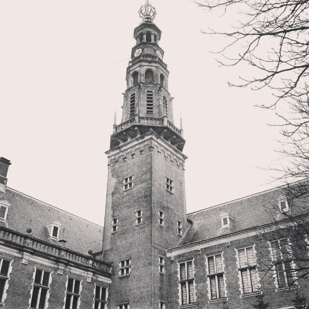 architecture, building exterior, built structure, low angle view, clear sky, tower, history, clock tower, city, old, tall - high, day, church, outdoors, sky, copy space, building, travel destinations, religion, no people